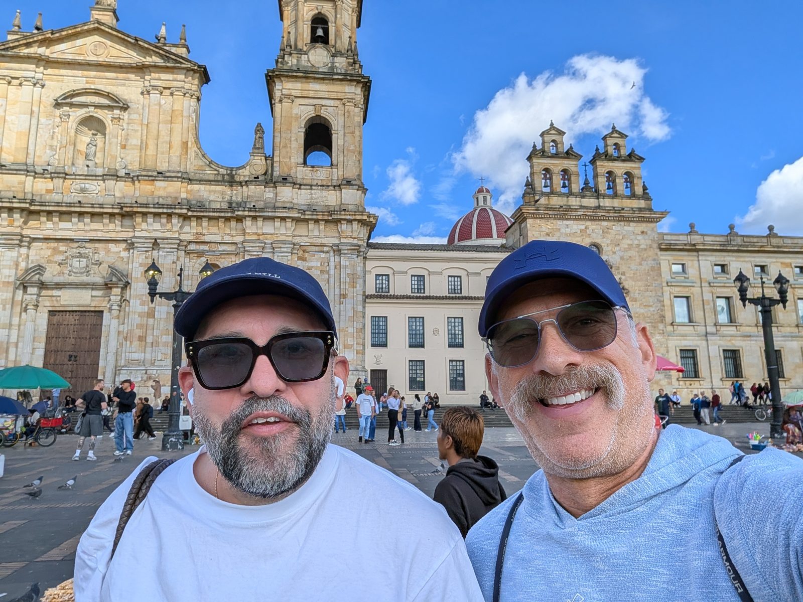 Plaza de Bolívar, caps on, both of us squinting.