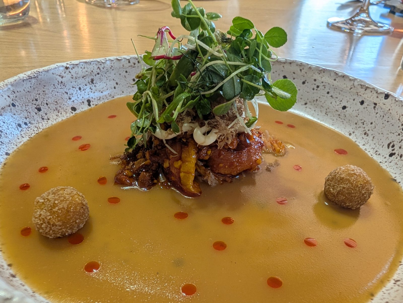 The broth course, with croquettes and a hill of greens.