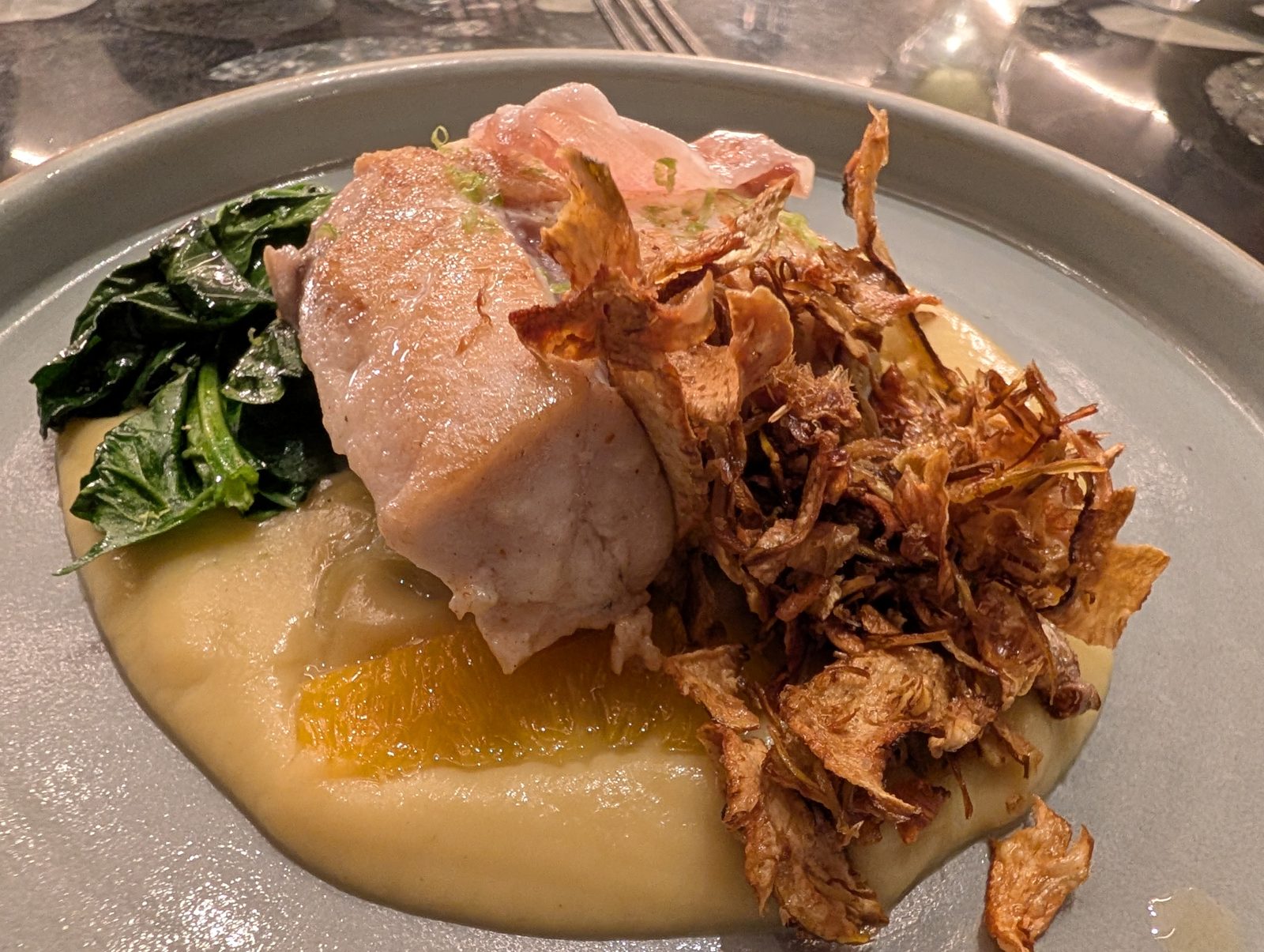 Fish on a purée, with crisped artichoke on top.