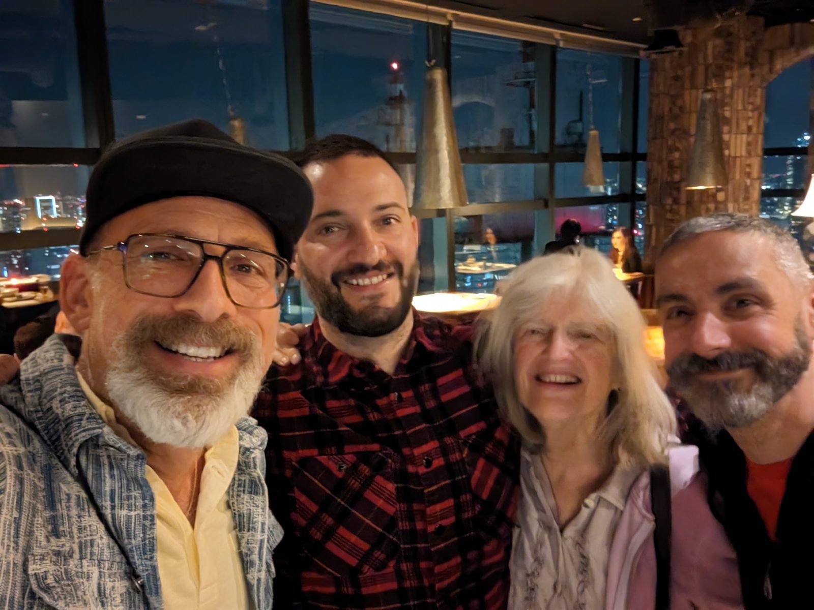 Dinner: Billy, Ari, Chris and Marcio, the city behind the glass.