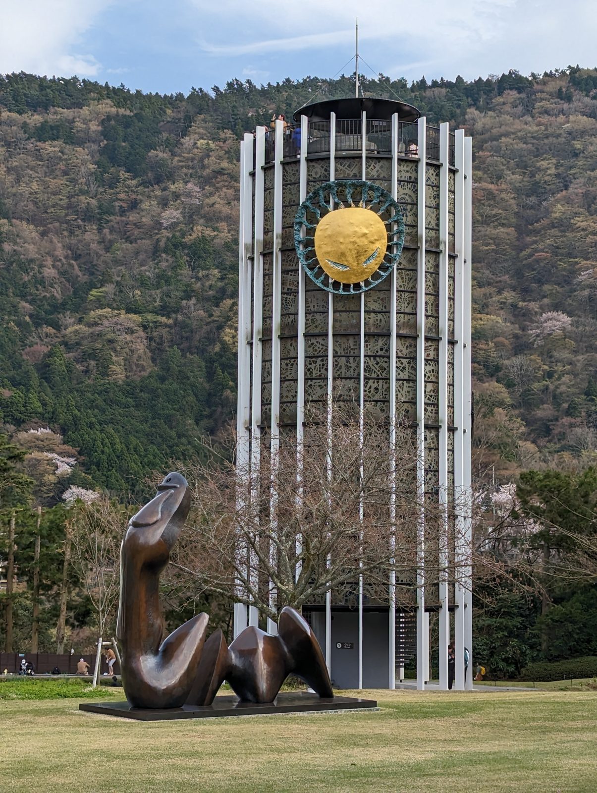 The Symphonic Sculpture tower, stained glass inside, with a bronze in front.