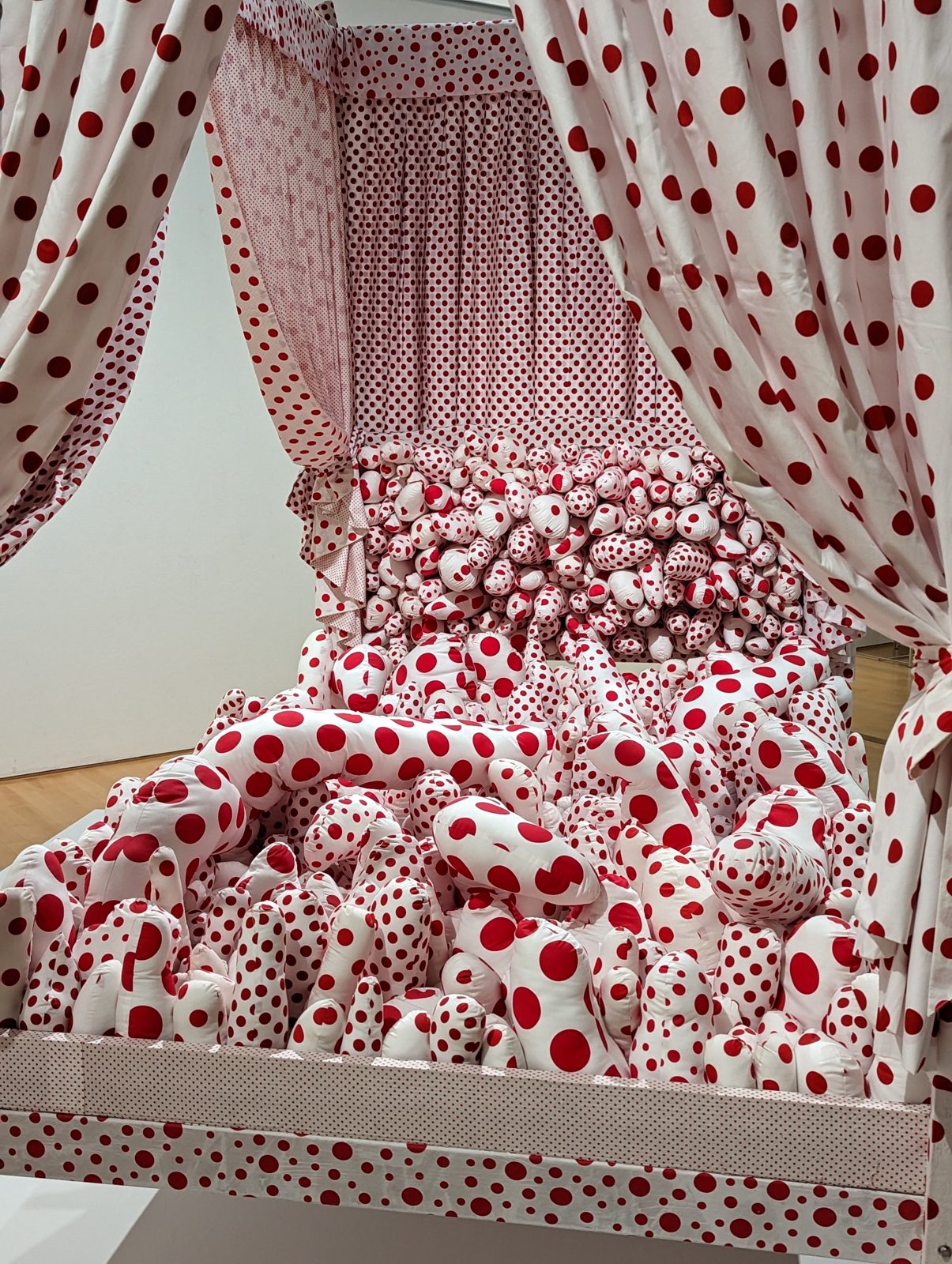 Yayoi Kusama's bed, dots on everything.