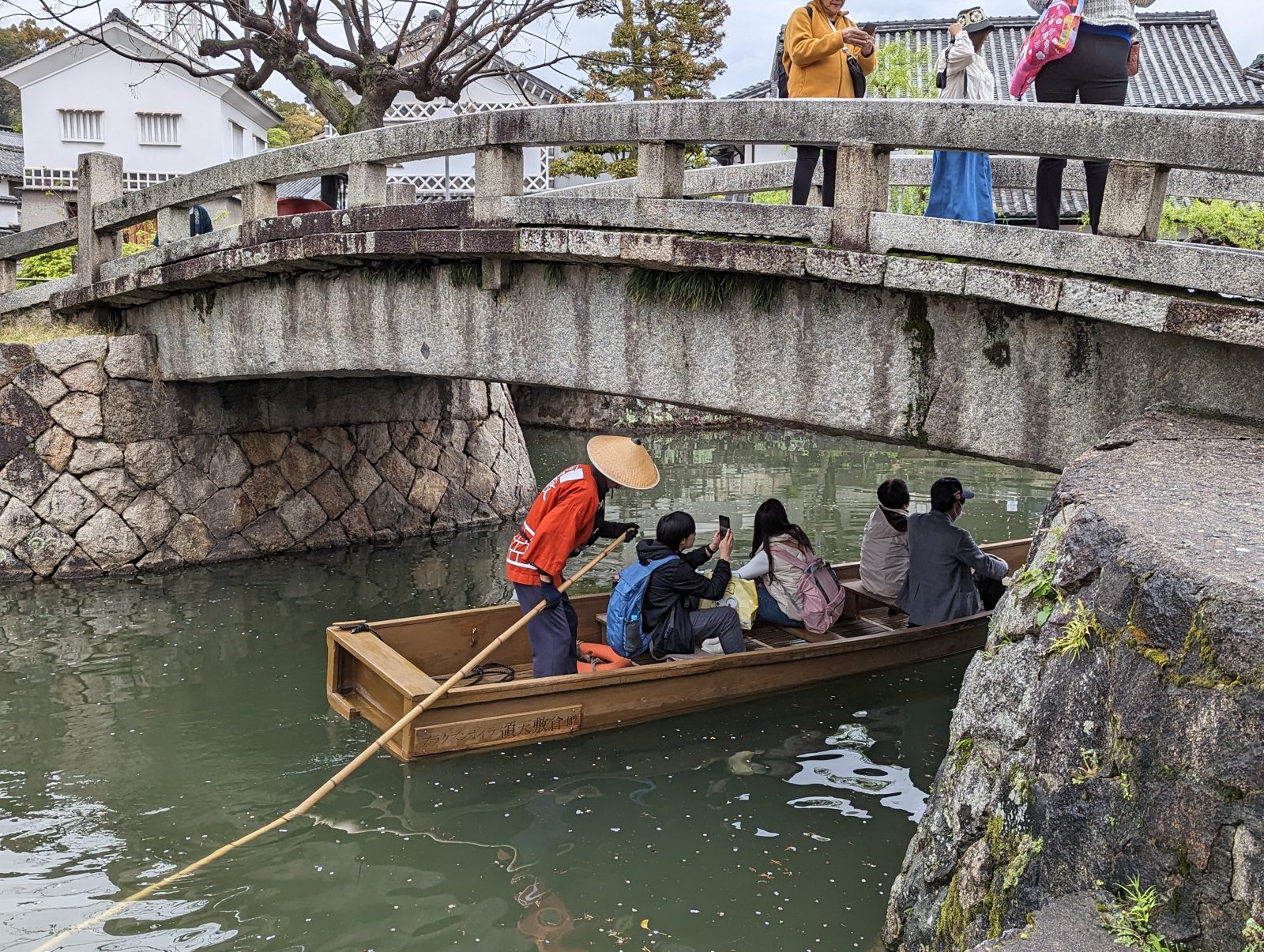 A boat under the stone bridge.