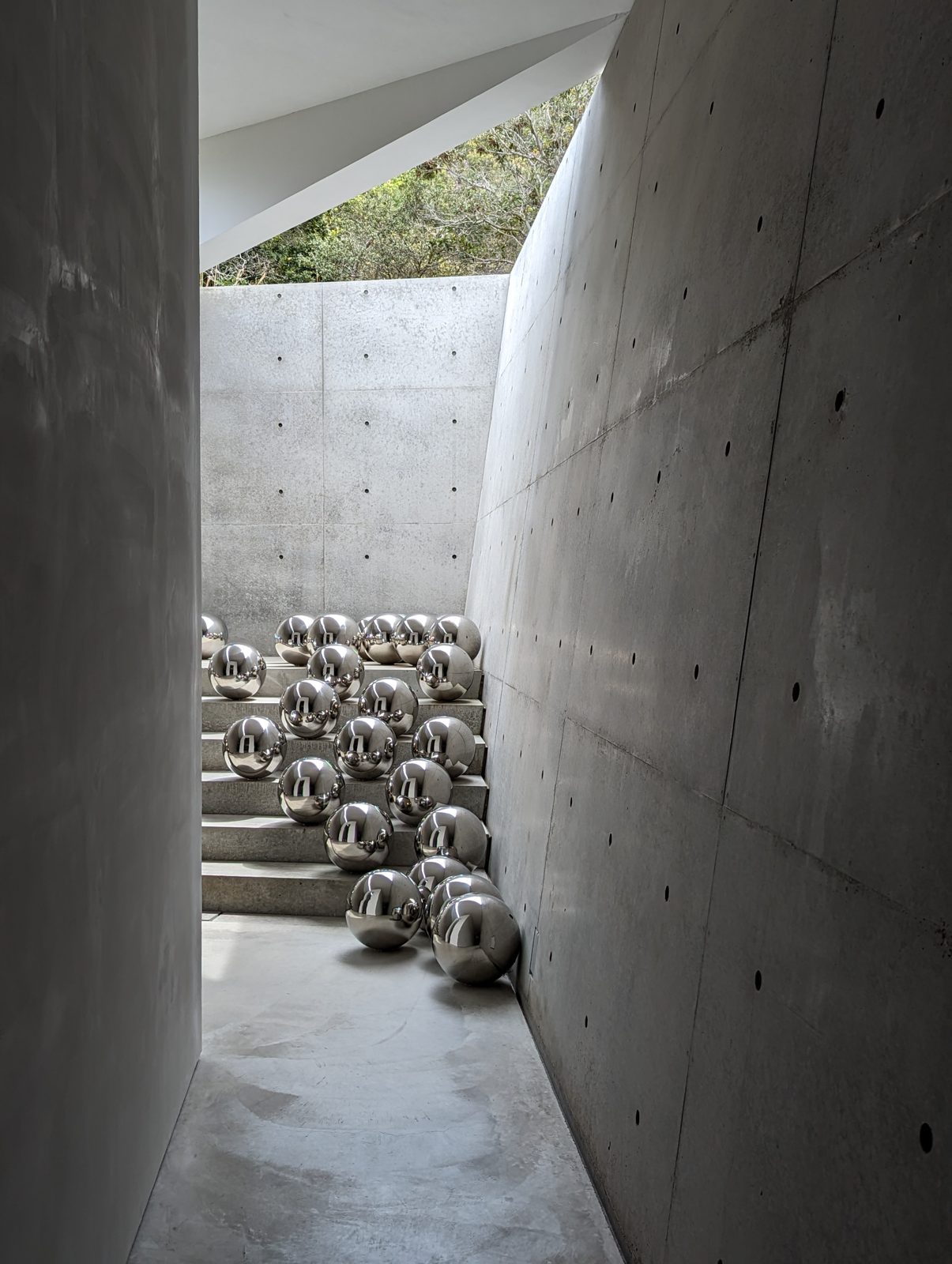 Spheres against Tadao Ando's concrete.